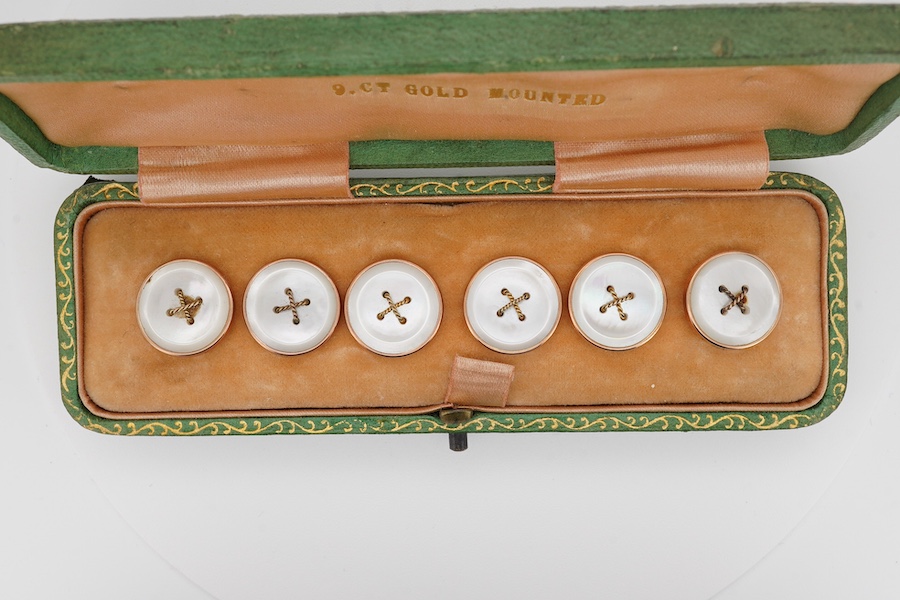 A set of six 9ct mounted mother of pearl dress studs, in a fitted gilt tooled leather case. Condition - fair to good